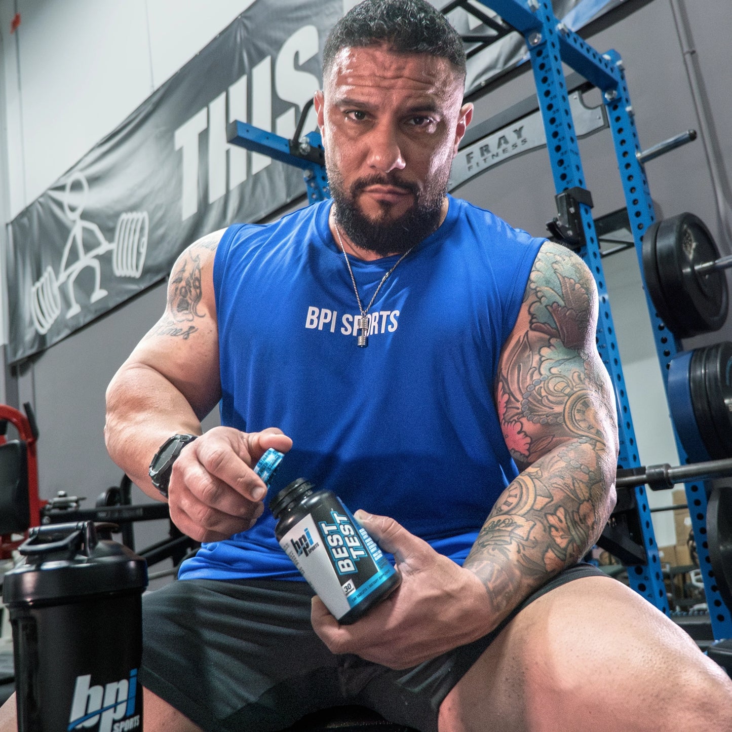 Male BPI's Athlete opening a bottle of Best Test