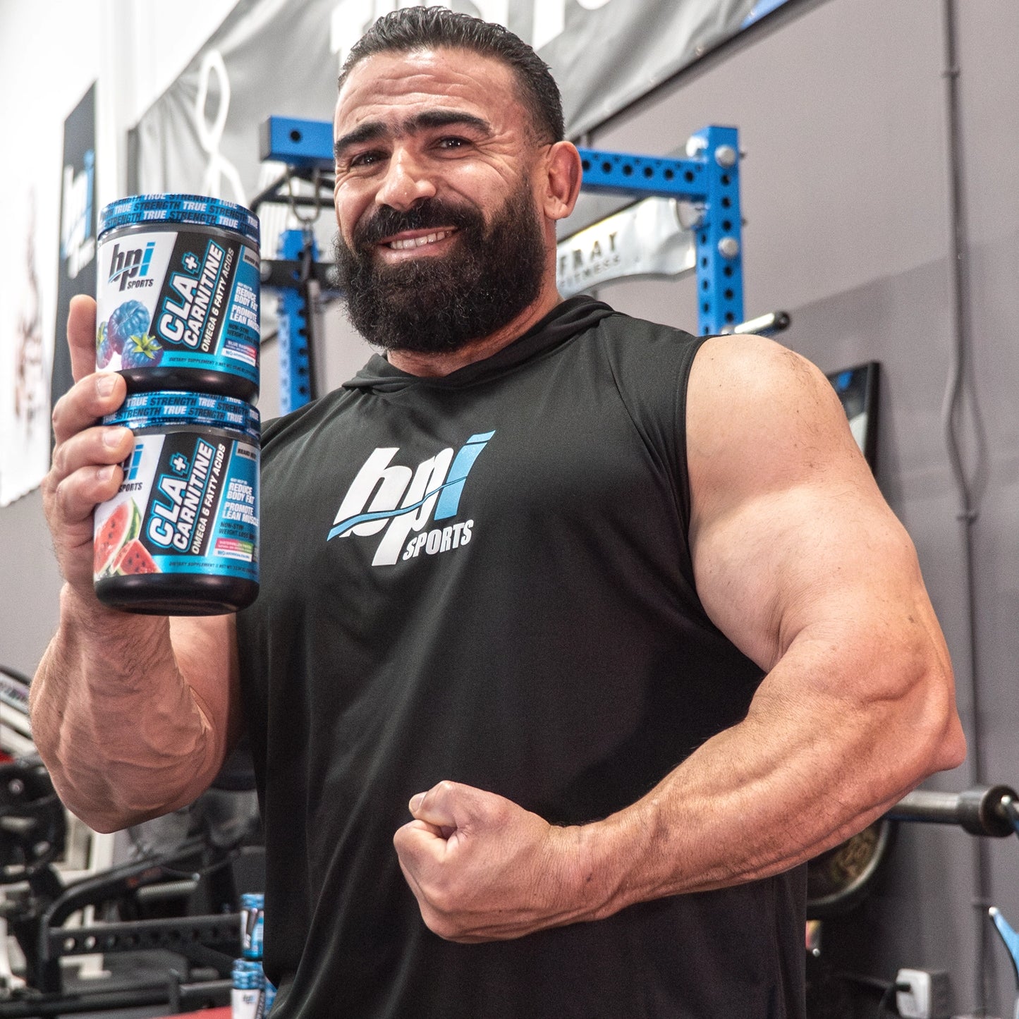 Kamal, BPI's Athlete with bottles of CLA + Carnitine