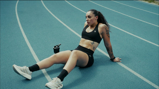 A BPI Sports athlete resting on a running track after a session